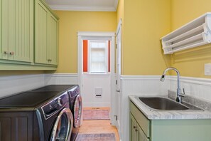 Wash & dryer and entrance to the half bathroom