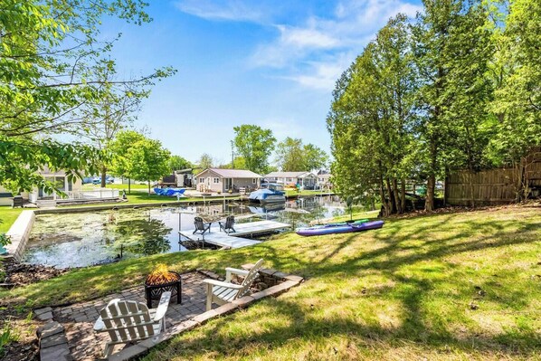 Backyard views with wood firepit and private pier on the water. You're connected to the Barbee Chain of Lakes!