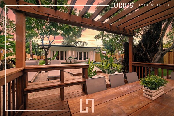 Including a wooden deck overlooking a tranquil lake.