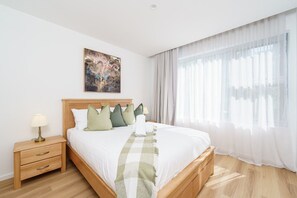 A comfortable queen-size bed with soft, professionally laundered linen for a restful night's sleep.