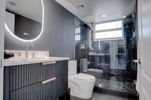 The second bathroom is located in the hallway just past the Living Room