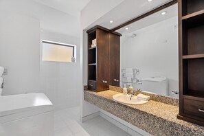 Bathroom equipped with washing machine & walk in shower