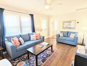 Living room features comfortable seating and a smart TV. 