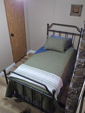 Twin size bed with luxurious linens and pillows