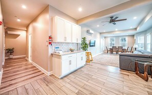 Spacious open-concept living area featuring a well-equipped kitchen