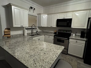 Newly remodeled kitchen with granite countertops.