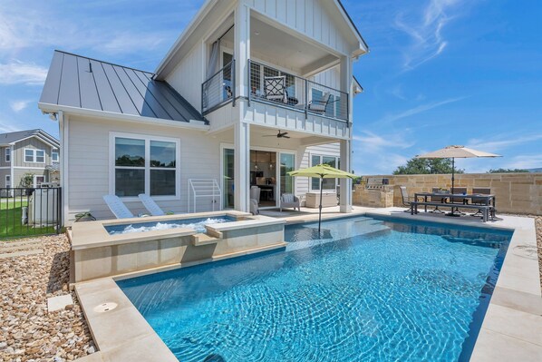 Back of home. Large pool and hot tub.