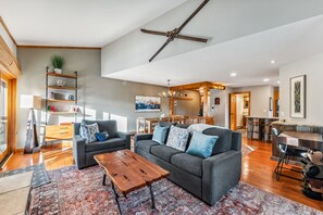Living room with desk, gas fireplace, and smart TV