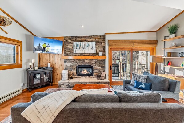 Living room with gas fireplace and smart TV