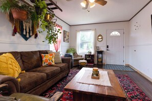 Living room is cozy and still gets a lot of natural light.
