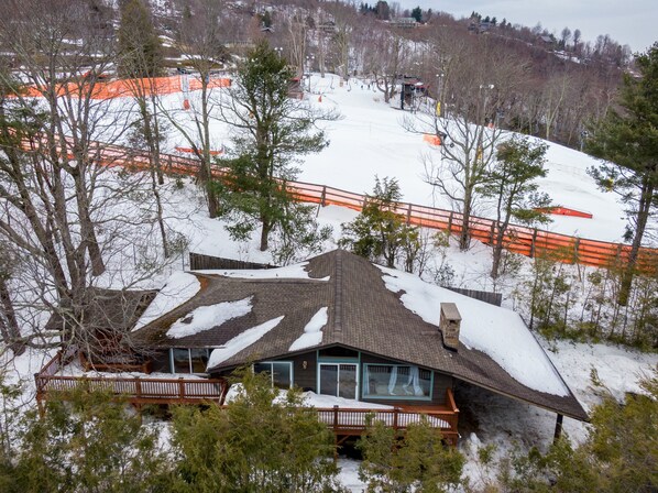 Winter aerial view of App Ski slopes behind the home