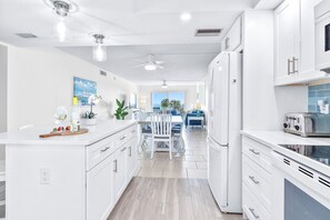 Stylish white kitchen with modern touches and plenty of natural light