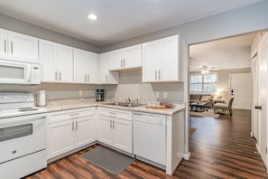 Fully equipped kitchen with appliances and access to the patio.