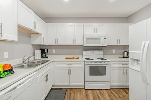 Unit 2: Fully equipped kitchen with appliances and access to the patio.