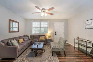 Unit 1 - Stylish open-concept living area with designer furnishings, Smart TV, and Fire Place.