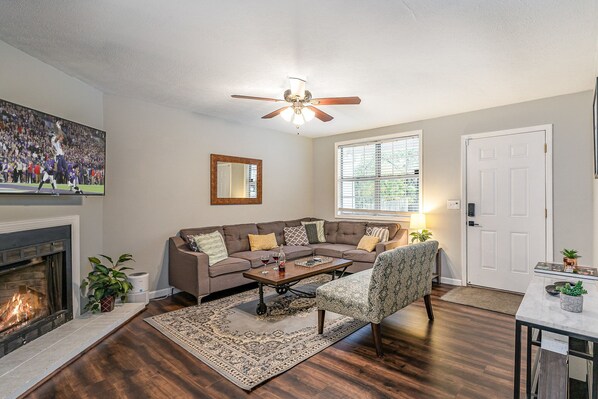 Unit 1 - Stylish open-concept living area with designer furnishings, Smart TV, and Fire Place.