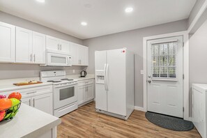 Unit 2 - Fully equipped kitchen with appliances and access to the patio.