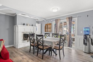 Bright dining area with a cozy fireplace and easy access to the outdoor patio—perfect for family meals and gatherings.