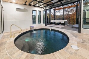 Dive into luxury! Our indoor pool features a separating door to the outdoor patio, allowing for seamless indoor-outdoor living.