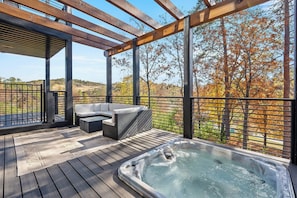 Step into paradise on our outdoor patio, perfectly situated by the deck and hot tub for ultimate relaxation and enjoyment.