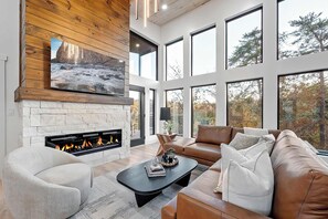 Bask in natural light and stunning views through our expansive windows, perfectly complemented by the warmth of the fireplace.