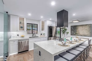 Updated kitchen with stainless steel appliances and gas cooktop