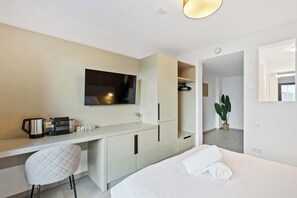Compact Yet Elegant Interior – Smart layout featuring a comfortable bed, desk, and entertainment area.