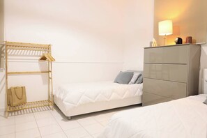 A serene bedroom with twin beds, where comfort meets style.