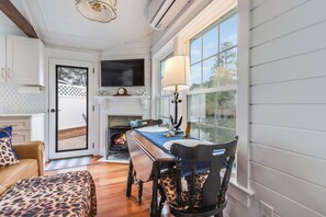 Dining space with water view, TV, and electric fireplace 
