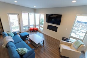 Bright living space with gas fireplace, and Smart TV
