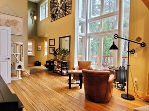 Gorgeous light filled living area with lovely nature filled views