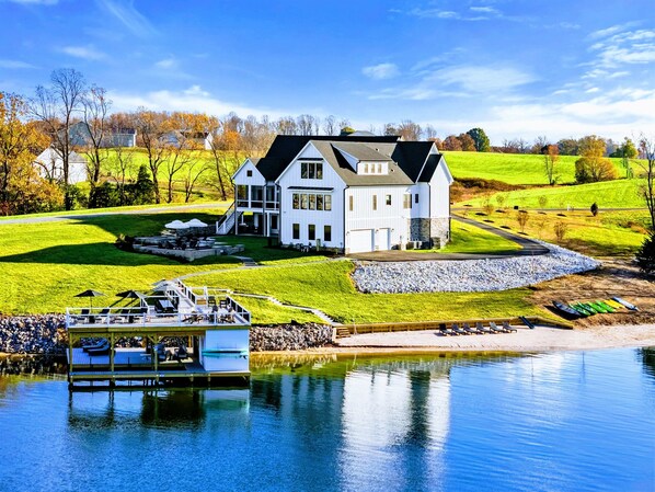 Spacious modern farmhouse retreat with a luxurious outdoor patio, firepit, and spa, surrounded by serene nature views.