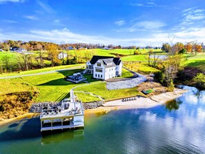 Stunning lakeside estate with a private beach, and luxurious outdoor amenities, offering a perfect blend of relaxation and adventure.