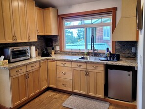 Small kitchen has electric stove top, microwave,fridge,&convection toaster oven