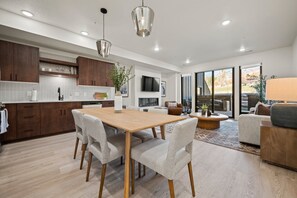 The open-concept living space, complete with a dining area, facilitates effortless conversation with family and friends.