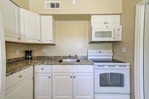 Full kitchen with stove, microwave, and cookware—great for extended stays or travel nurses cooking at home.