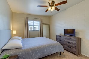 Private bedroom with a queen bed, blackout curtains, and smart TV—ideal for solo travelers or couples.