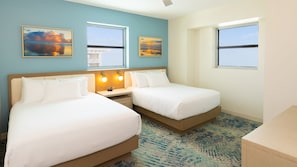 Sunlit bedroom with twin beds and a serene atmosphere, making it perfect for a relaxing retreat.