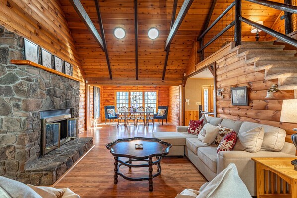 The living room boasts high ceilings and skylights, creating a spacious and airy ambiance