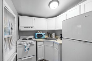 Clean and Tidy Kitchenette
Sanitized surfaces, organized storage, and a stainless steel sink ensure a hygienic cooking space.

