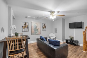 Modern Living Room with Smart TV
Unwind in a cozy living space featuring a mounted flat-screen TV, stylish entertainment console, and a comfy sofa perfect for streaming your favorite shows.

