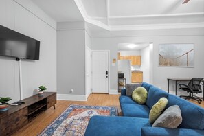 Modern Living Room with Smart TV
Unwind in a cozy living space featuring a mounted flat-screen TV, stylish entertainment console, and a comfy sofa perfect for streaming your favorite shows.