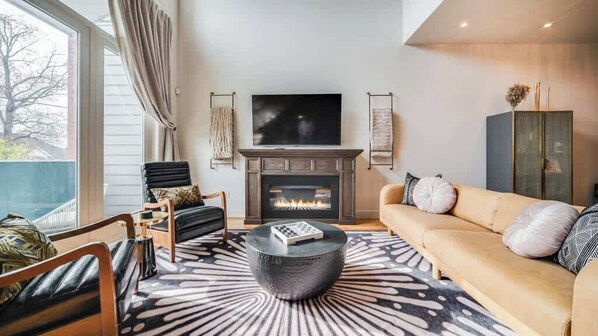 Living Room: Perfect spot to relax with a book or enjoy a movie night! This living room features a TV for your entertainment and a cozy sofa set.