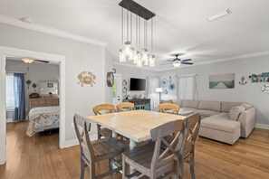 Dining/Living Area - The open concept design of this great cottage features plenty of space for spending quality time together. Enjoy meals at the dining area with seating for 6, or awesome conversation lounging on the sectional sofa.