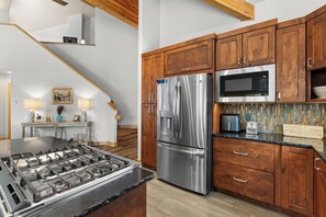 Full kitchen featuring all stainless steel appliances, air fryer, and five-burner stovetop.