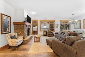 Living room area featuring a gas fireplace, queen sleeper sofa, and access to the private balcony.