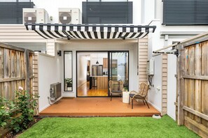Backyard with deck, outdoor furniture and BBQ
