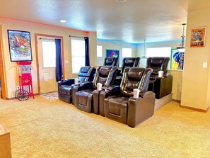 Elegant 6-seater theater room with a popcorn machine, offering the perfect setting for an unforgettable movie experience
