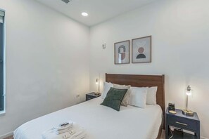 The primary suite boasts a plush queen bed & private ensuite bath