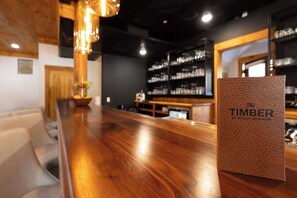 Crafted for Comfort: The Timber's bar top showcases rich woodgrain detail, perfectly complementing the curated menu of cocktails and shareable bites.






